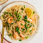 Lemon garlic shrimp pasta on a plate with a fork.