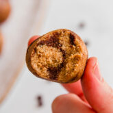Person holding a chocolate swirl energy bite.