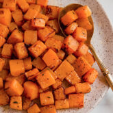 Butternut squash with a spoon on a plate.
