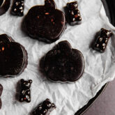 Black Halloween gummies on a lined dish.