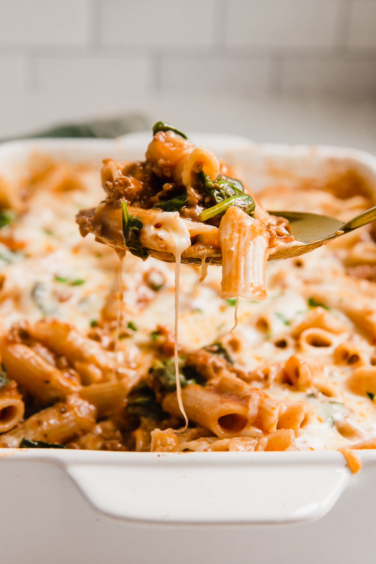A spoon scooping a no boil pasta bake. 