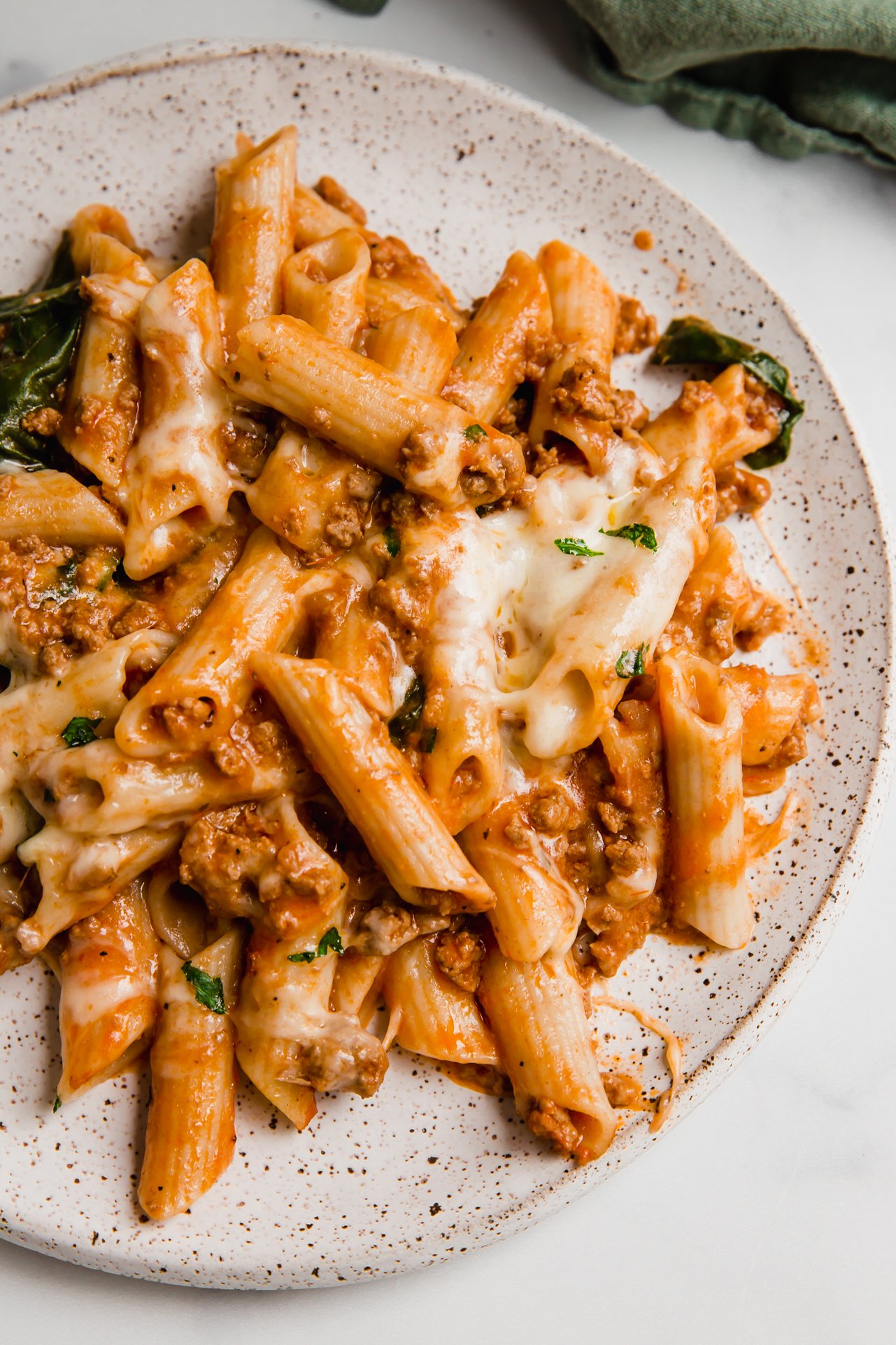 No boil pasta bake on a plate covered with melted cheese. 