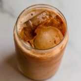 Pumpkin cold brew in a glass with ice.