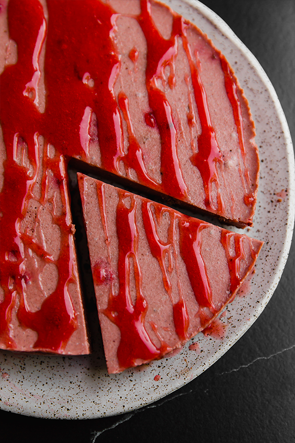 A slice cut out of the red velvet cheesecake.