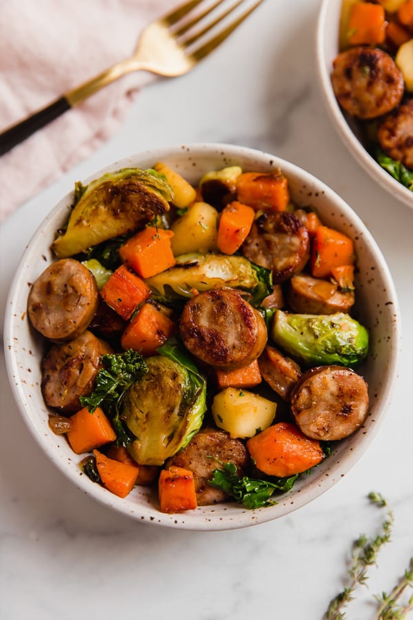 A bowl filled with apple chicken sausage and harvest vegetable skillet.