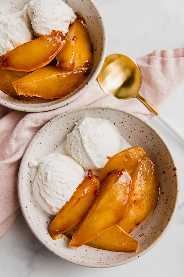 Caramelized pears with ice cream in a bowl.