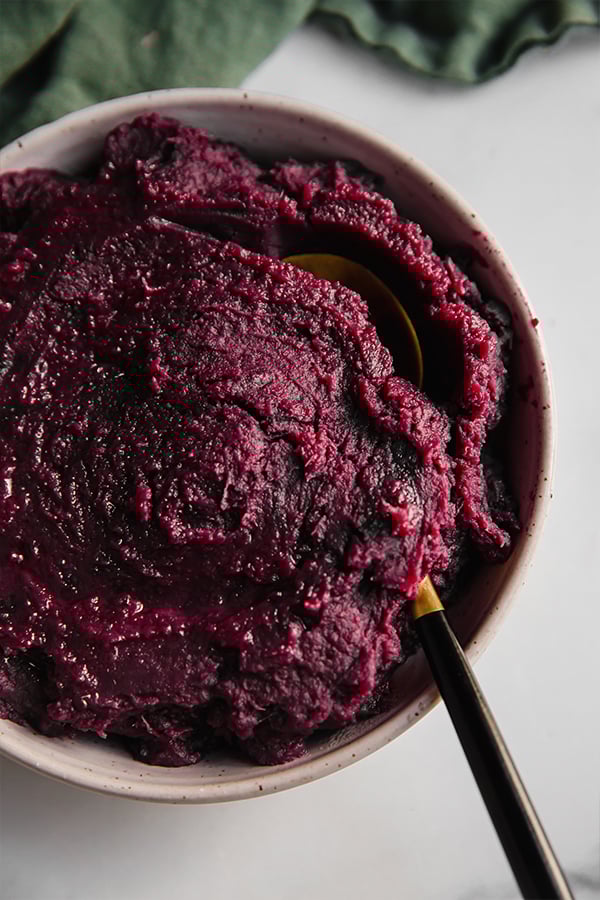 A bowl of purple mashed sweet potatoes.