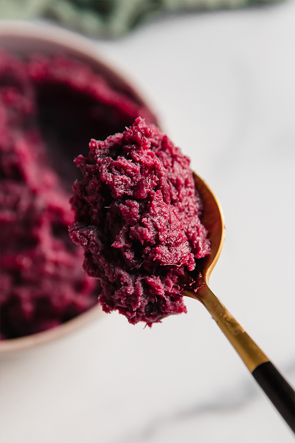 A bite of purple mashed sweet potatoes.