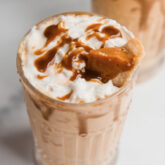 Tall glass filled with pumpkin pie milkshake.