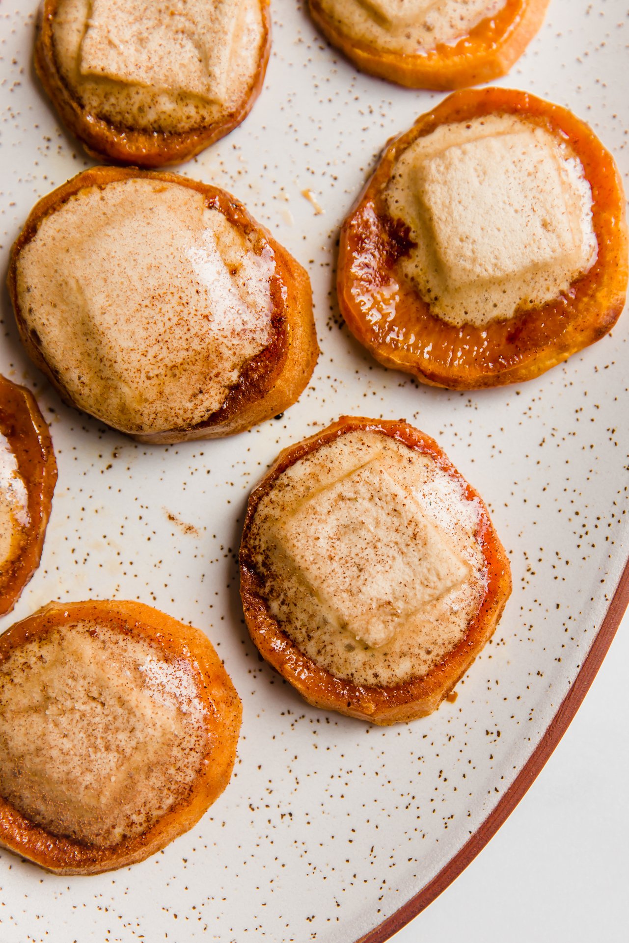 Sweet potato casserole bites with melted marshmallows on a plate.