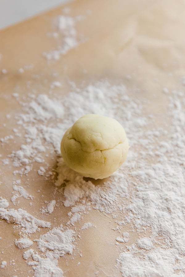 A ball of dough on a floured surface.