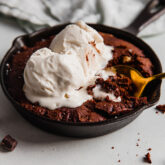 Spoon scooping from a brownie skillet.