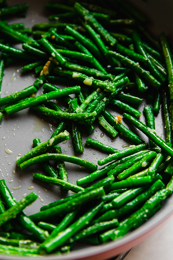 Green beans cooking in a pan.