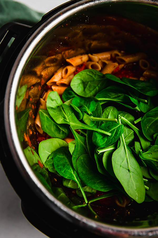Spinach added on pasta in the Instant Pot.