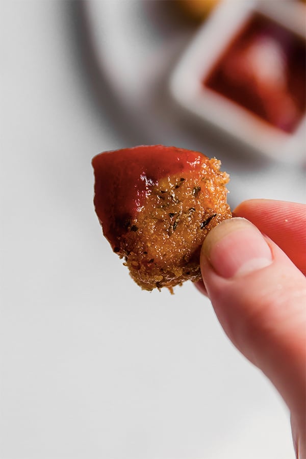 A pork panko chicken nugget with dipping sauce.