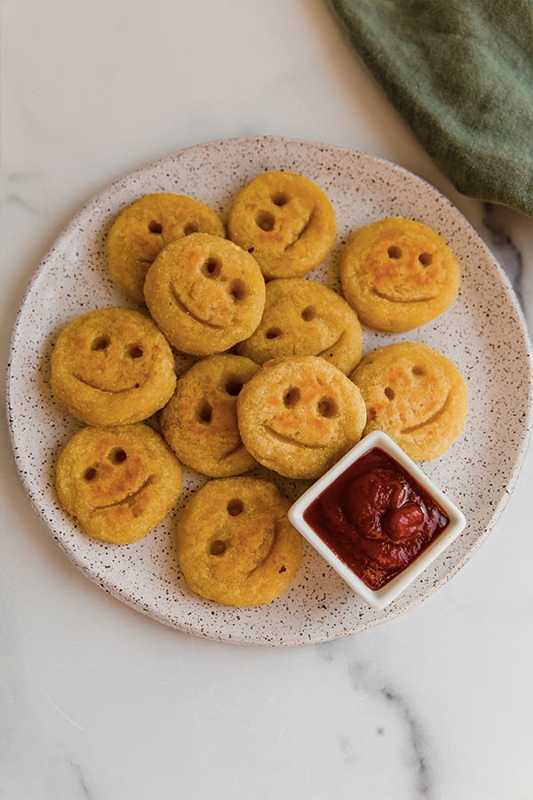 A plate of sweet potato smiley fries with ketchup!