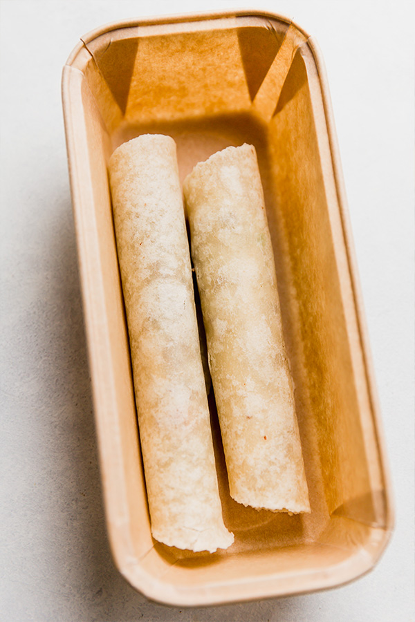 A contained with 2 rolled tortillas.