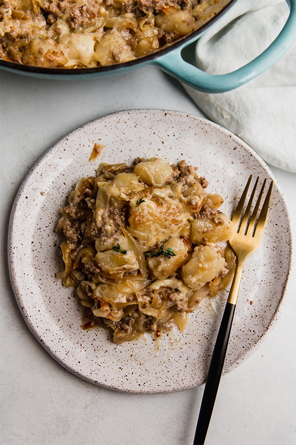 A serving of French Onion Gnocchi Skillet on a plate.
