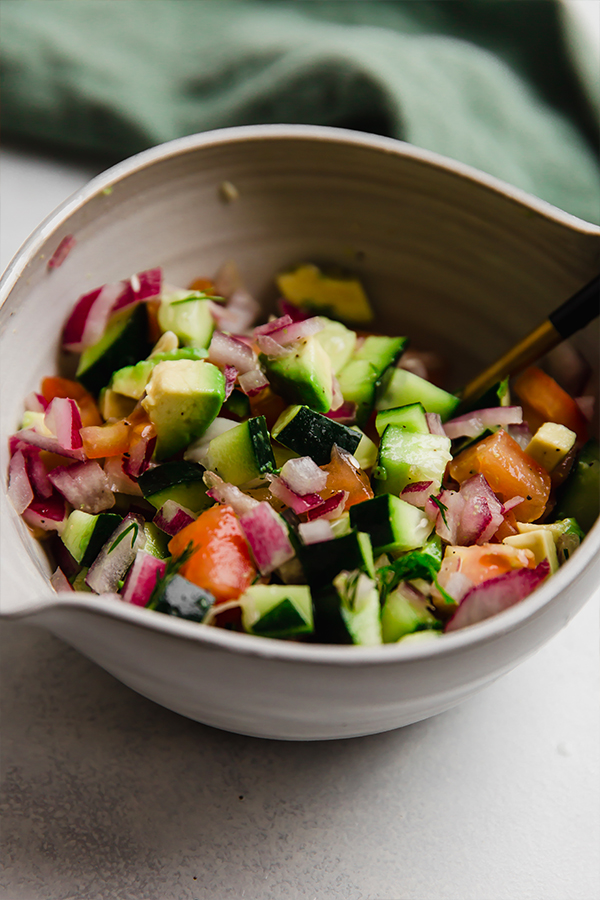 A bowl of chopped vegetables for Greek Salsa Salmon bowls.