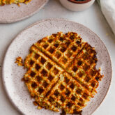 Plate with a sweet potato hashbrown waffle.