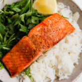 Plate of salmon, rice, and greens.