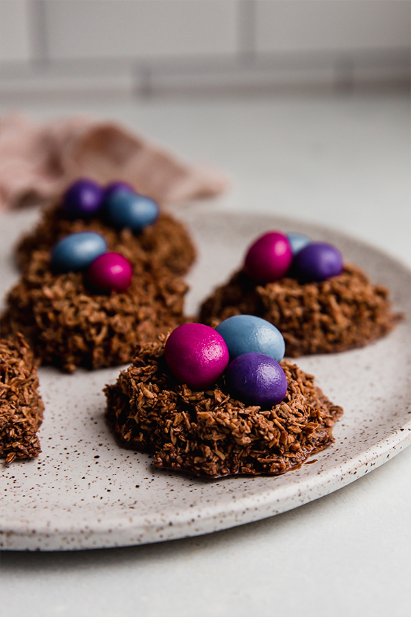 Chocolate coconut Easter egg nests on a plate.