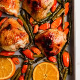 Citrus glazed chicken on a sheet pan with vegetables.