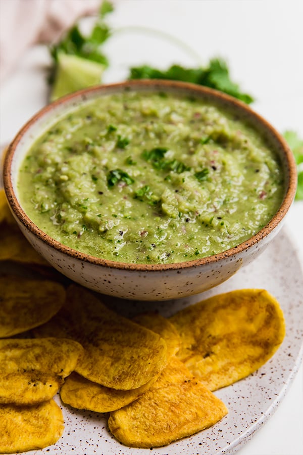 A bowl of AIP nightshade-free salsa verde with plantain chips.