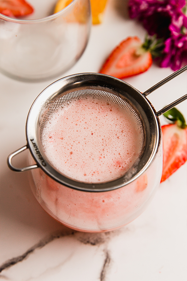 A cup of strawberry mimosa mocktail.