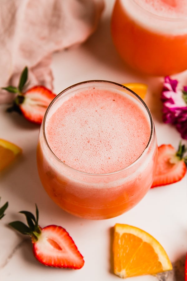 A cup of strawberry mimosa mocktail.