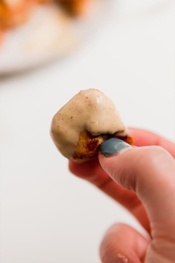 A copycat grilled chick-fil-a nugget dipped in sauce.