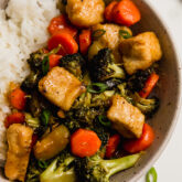 Lemon chicken stir fry with a side of rice in a bowl