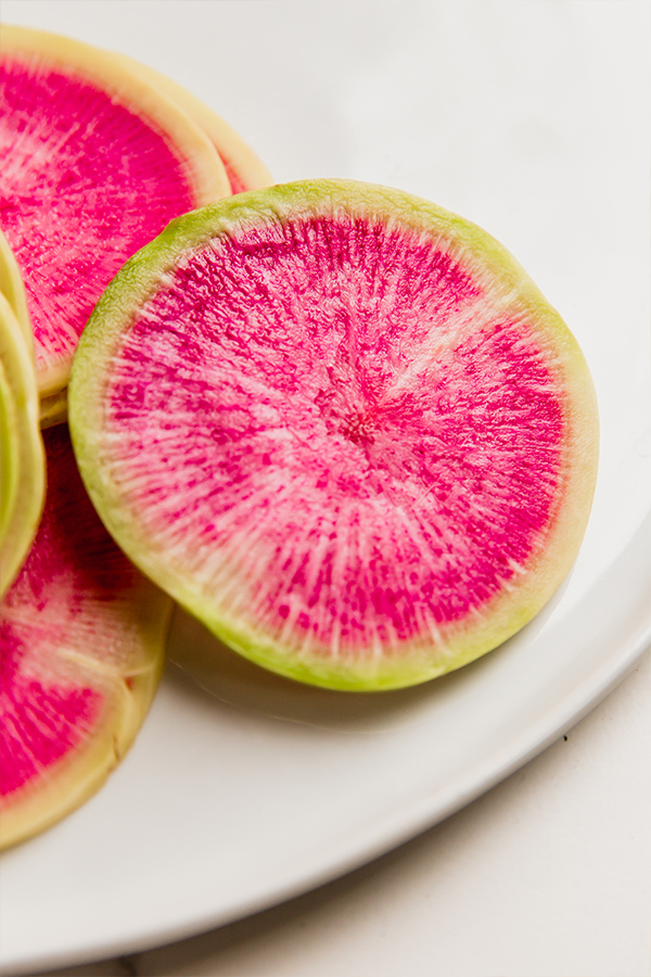 raw watermelon radish on a plate.