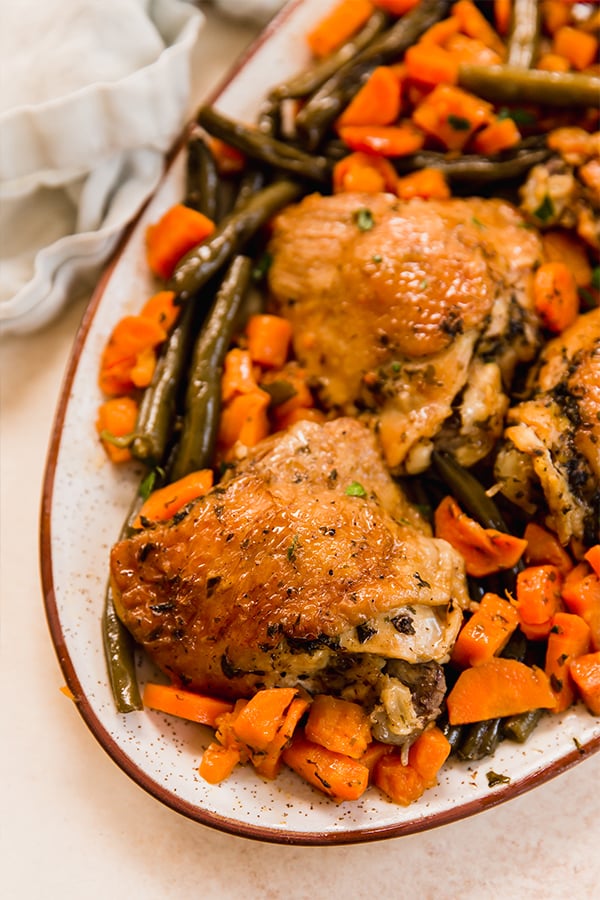 A plate filled with balsamic chicken and vegetable.