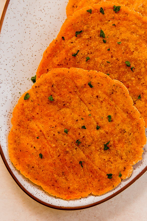 A plate with sweet potato flatbread on it.