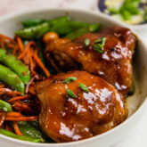 Teriyaki chicken things on a plate with vegetables.
