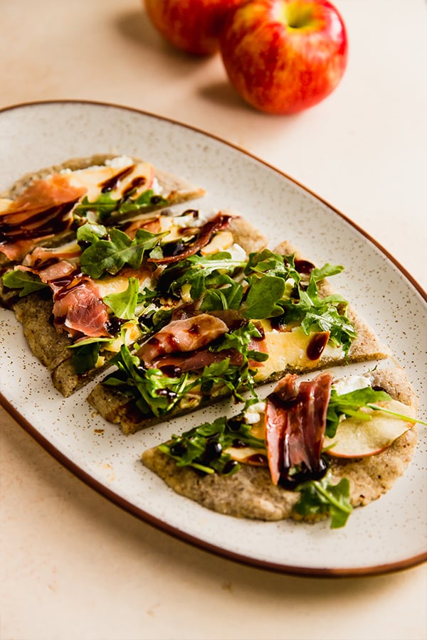 An apple balsamic flatbread on a serving plate