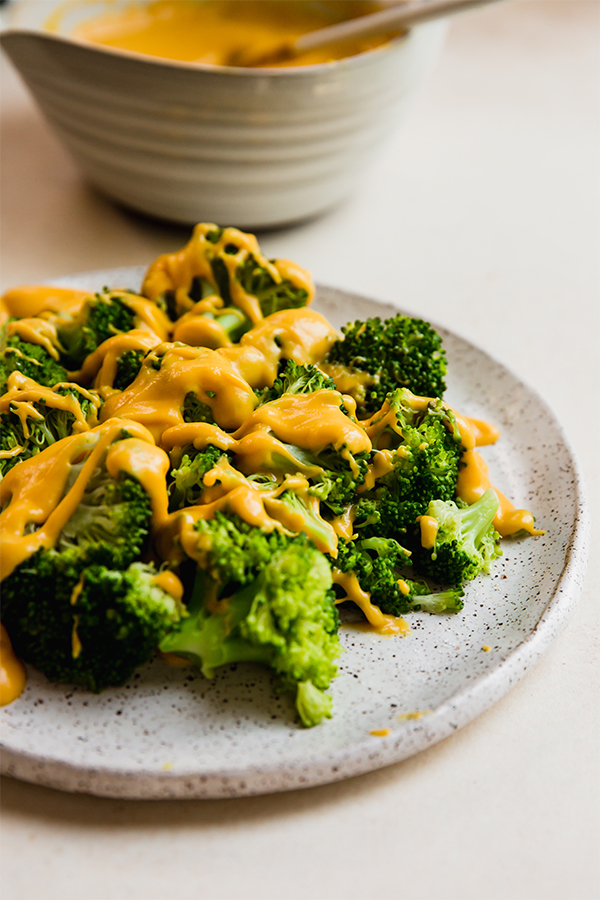 Vegetables on a plate with dairy free cheese sauce over it
