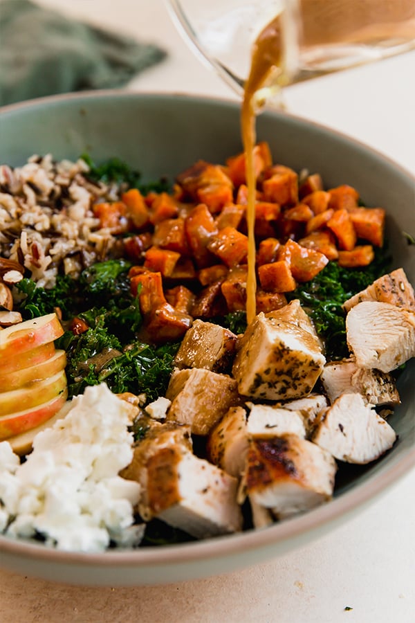 The copycat Sweetgreen Harvest Bowl with dressing pouring over it.
