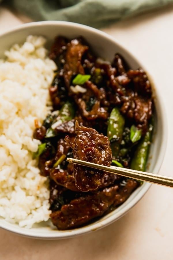 Honey garlic beef stir fry with rice in a bowl.