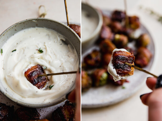 Bacon wrapped brussels sprouts dipping into sauce.