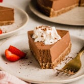 Slice of chocolate pie on a plate with a fork.