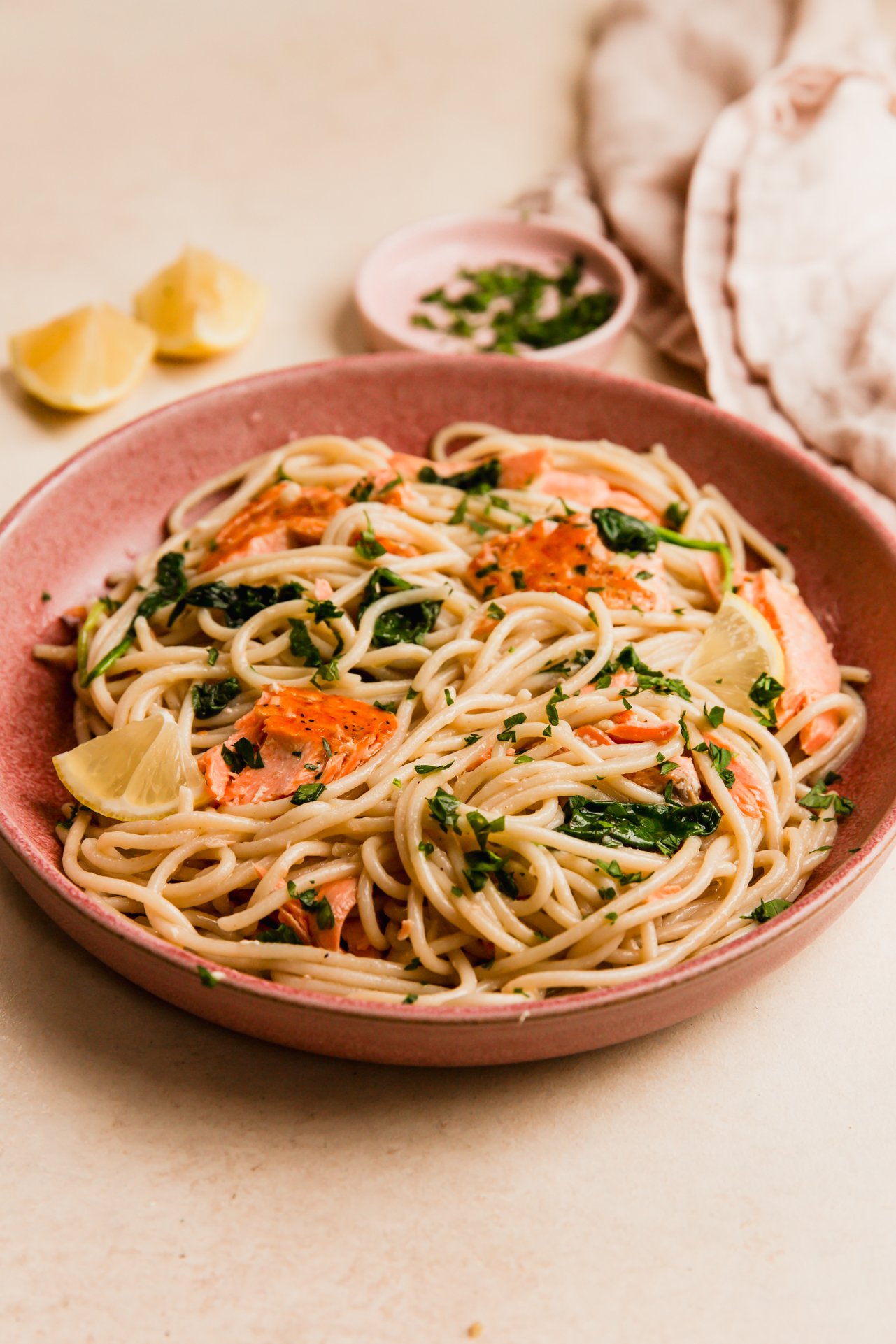 Lemon salmon pasta in a pink bowl.