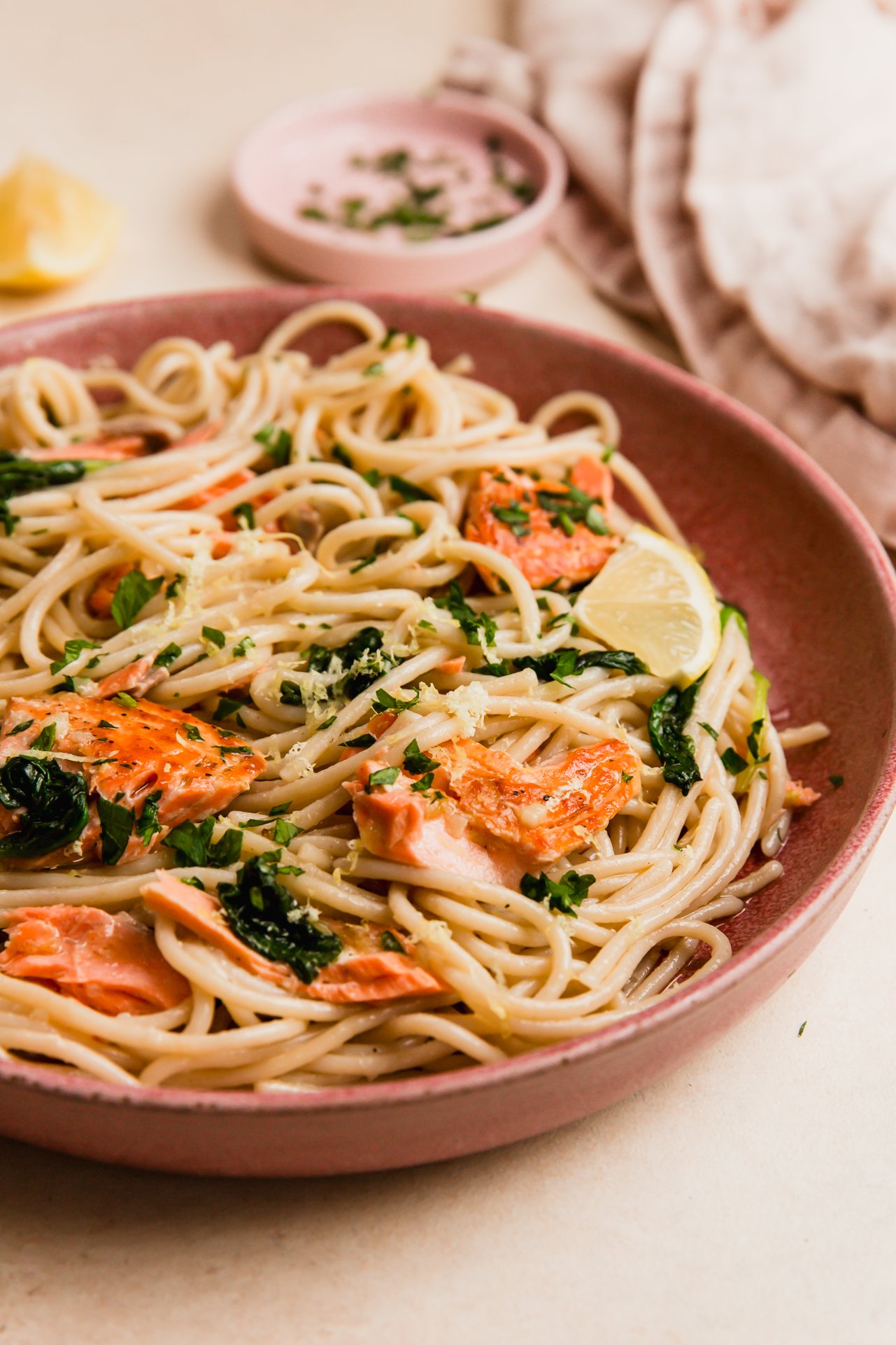 Lemon salmon pasta in a pink bowl.
