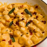 Cauliflower gnocchi with creamy butternut sauce in a pan.