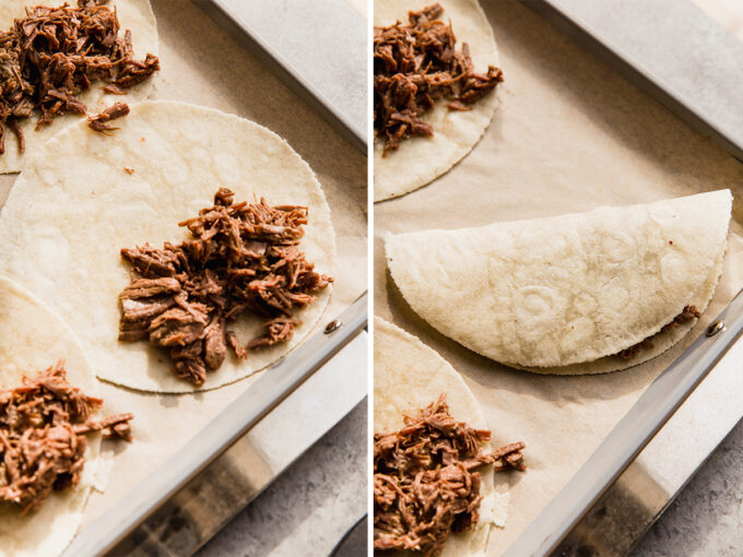 The shredded beef tacos on a baking sheet before and after folding them.
