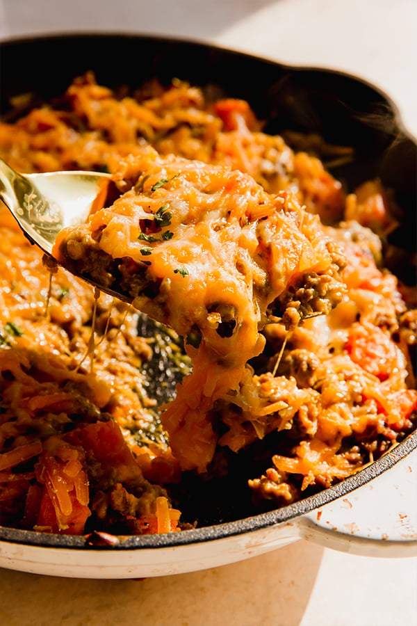 A skillet of dairy-free cheesy beef & sweet potato skillet.