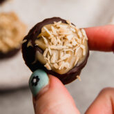 Person holding a Samoa banana bite.