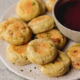 AIP pizza bites on a plate with a bowl of dip.