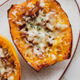 Two French onion spaghetti squash boats on a platter.